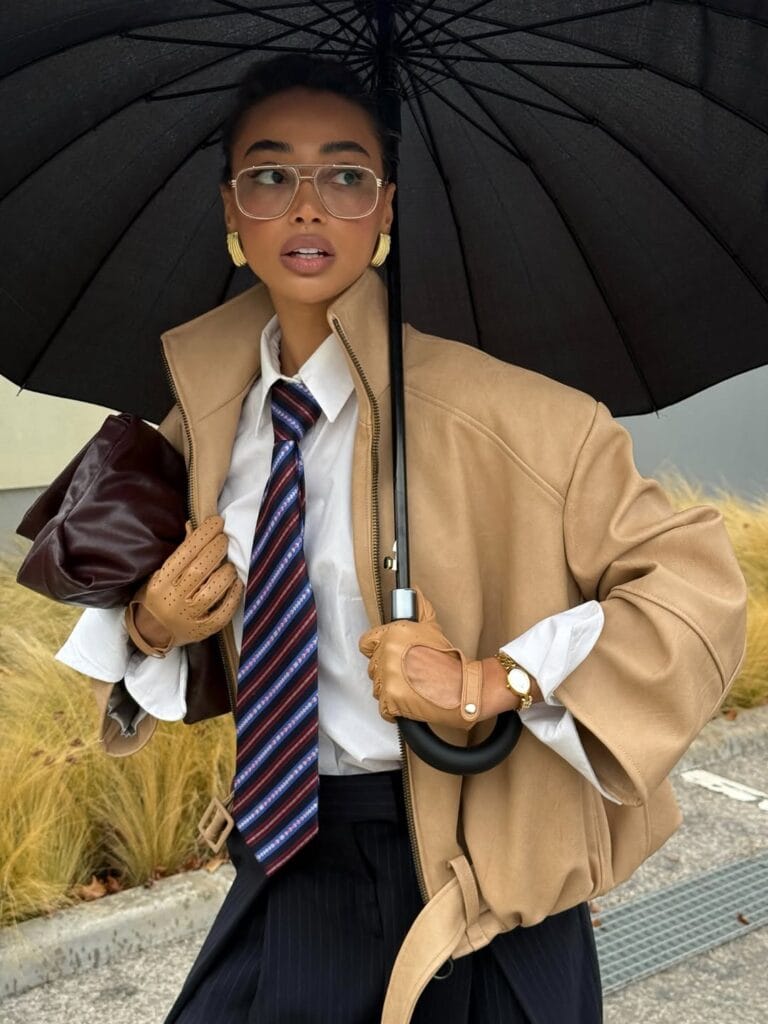 2026 fashion trends, oversized camel blazer with white shirt, striped tie, gold earrings, '80s power dressing