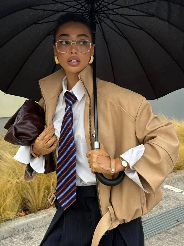 2026 fashion trends, oversized camel blazer with white shirt, striped tie, gold earrings, '80s power dressing