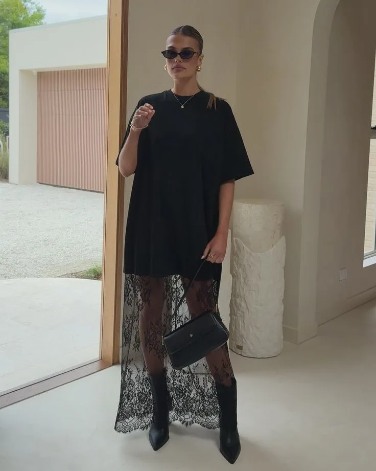 2026 fashion trends, black oversized tee over black lace maxi skirt, ankle boots, modern lace look