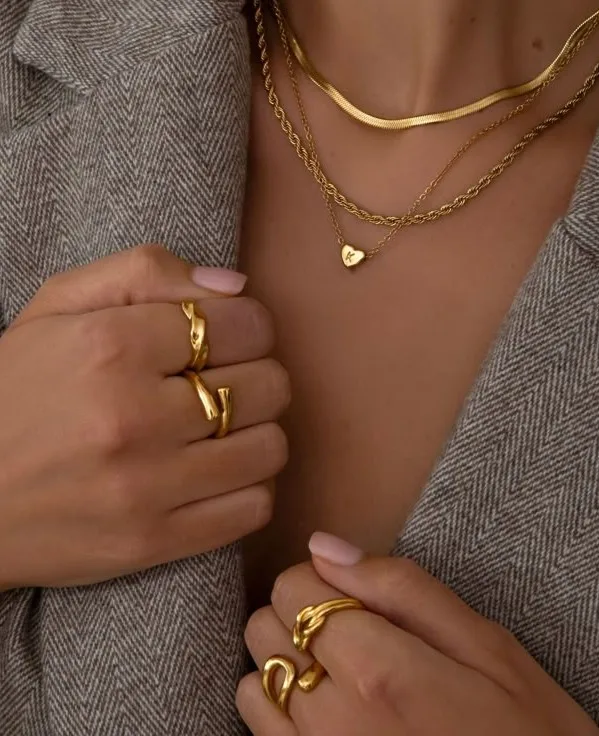 fashion trends 2026, layered gold necklaces with chunky sculptural rings, herringbone chain, heart pendant