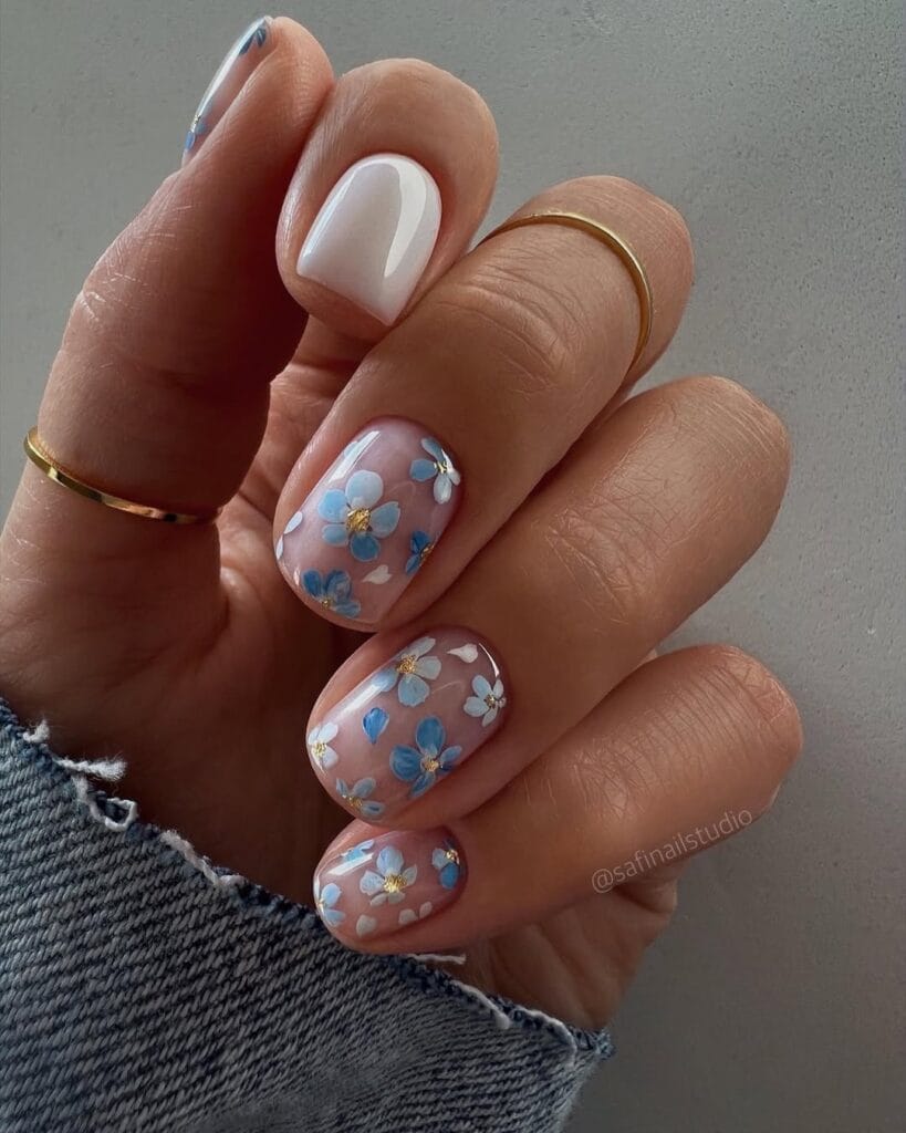 classy spring nails, short round nude pink nails with blue and white hand-painted flowers and gold details