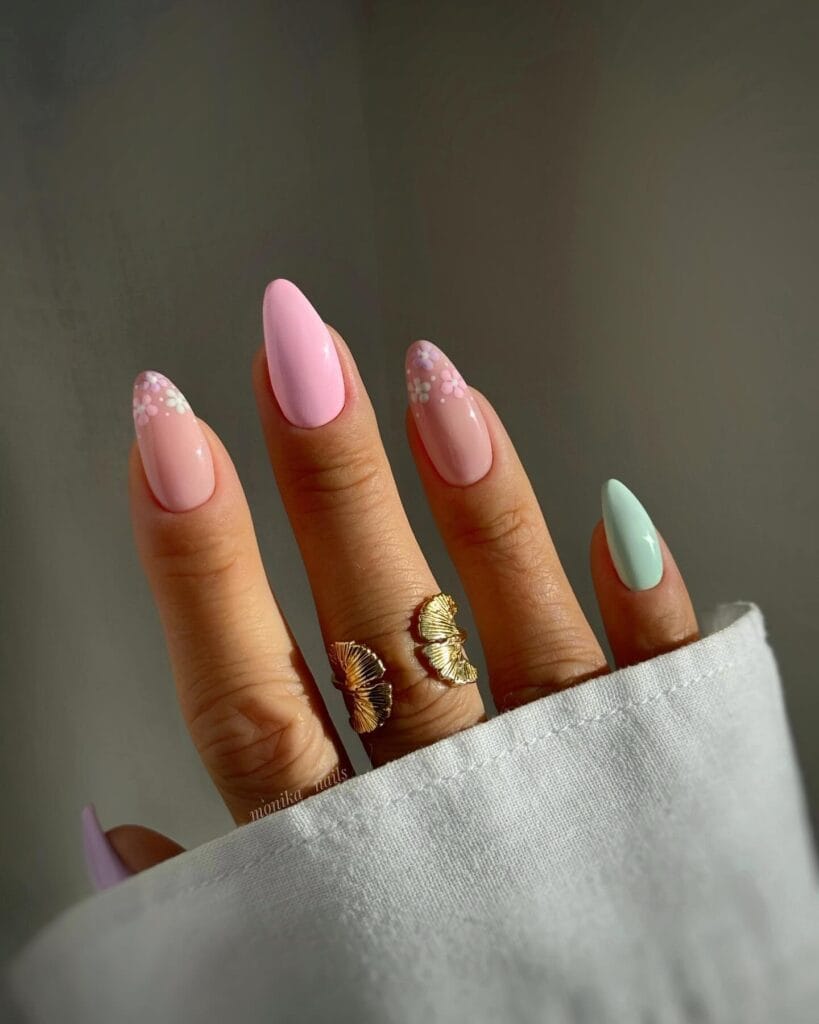 classy spring nails, almond baby pink and mint green nails with small white flower accents