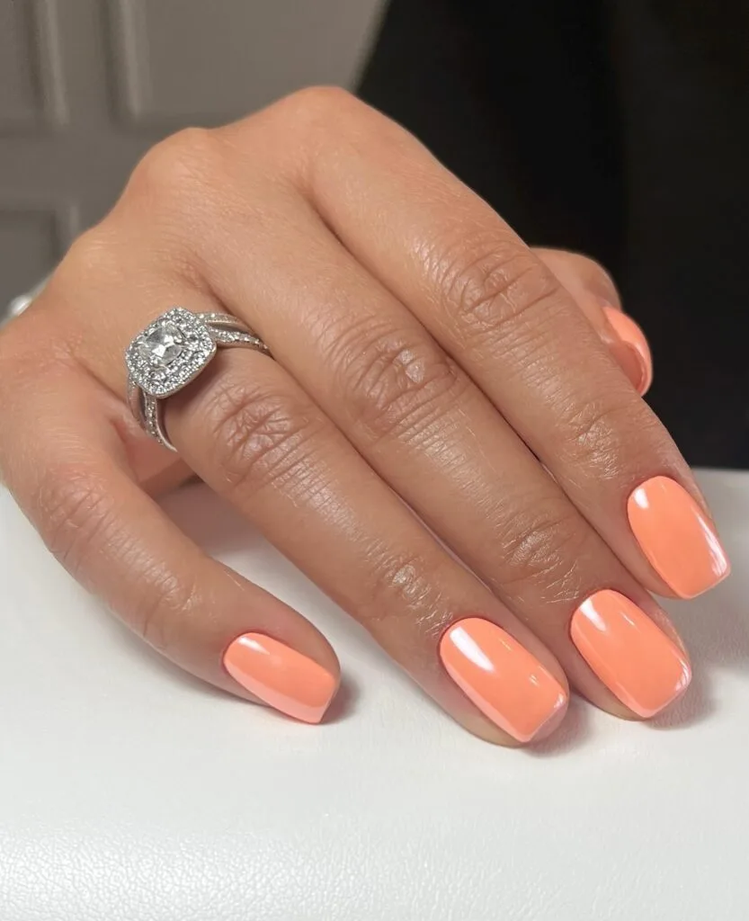 spring nail colors 2026, bright soft peach short square nails with diamond ring