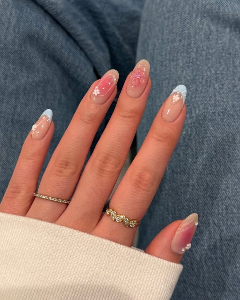classy spring nails, almond nails with pastel blue French tips, pink ombre, 3D flowers and glitter accents