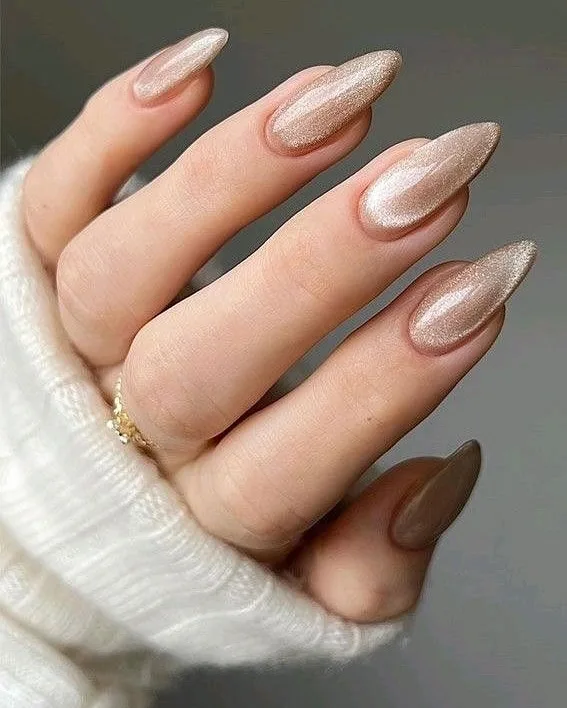 spring nail colors 2026, champagne gold glitter almond nails, sheer base