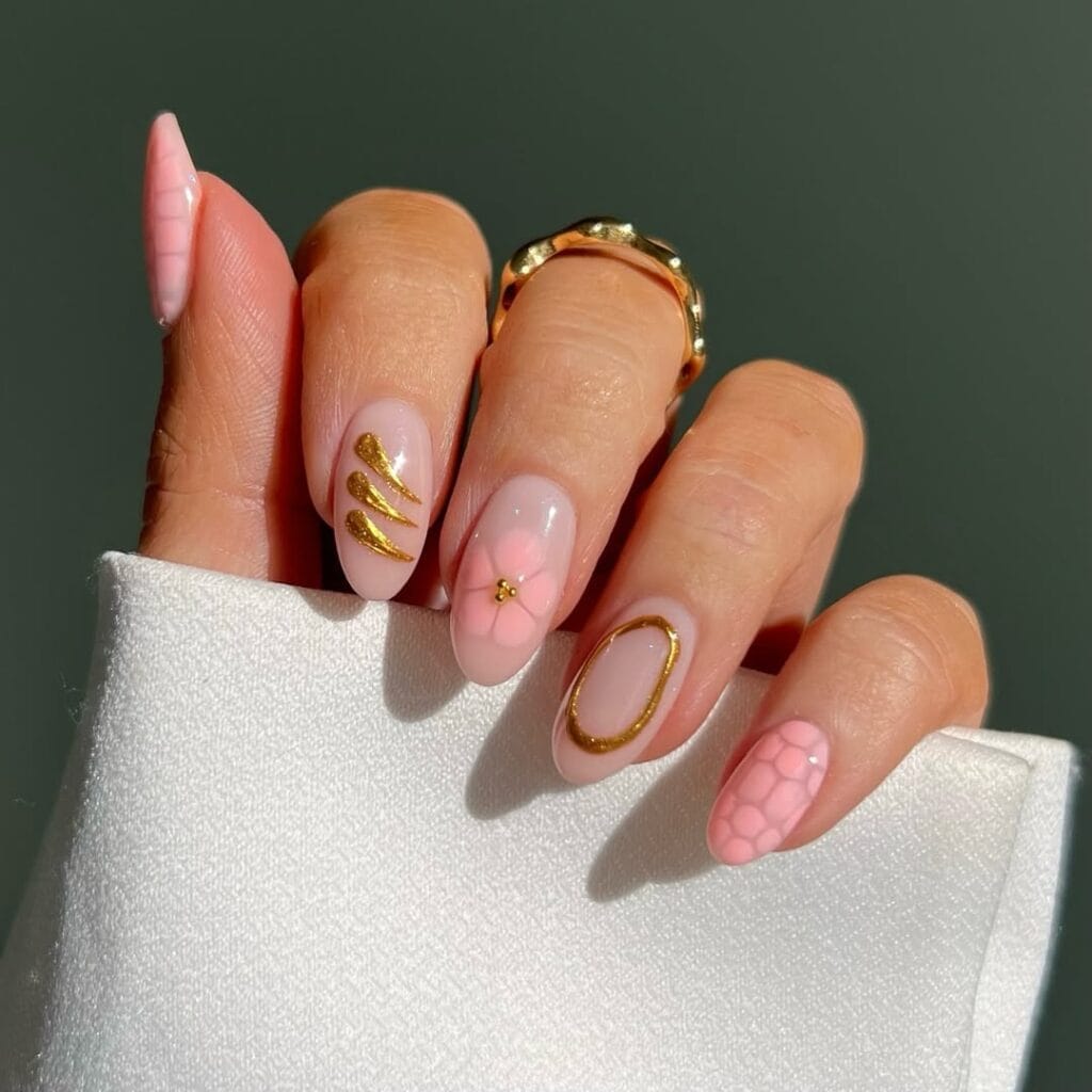 classy spring nails, almond nude pink nails with gold abstract art, pink flower, and croc texture accent