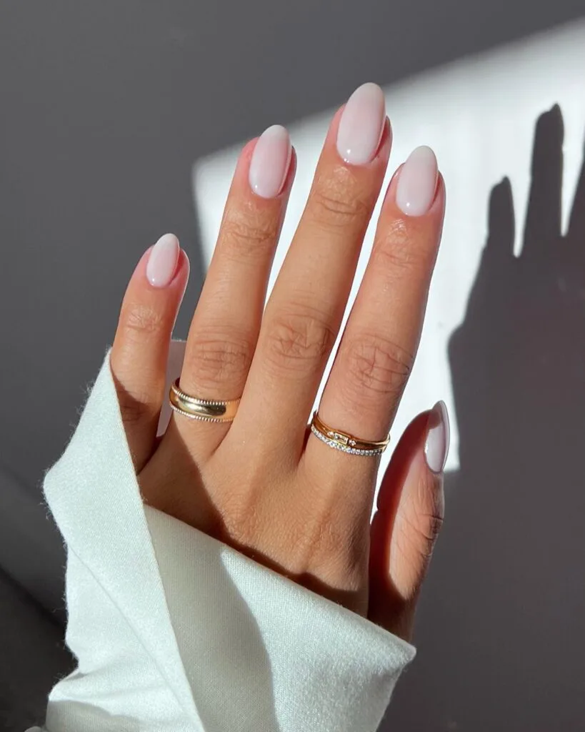 spring nail trends 2026, milky pink-white almond nails with sheer glossy finish