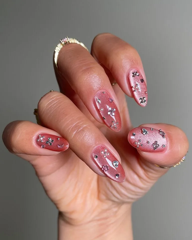 spring nail trends 2026, pink shimmer almond nails with gem clusters and pearl accents