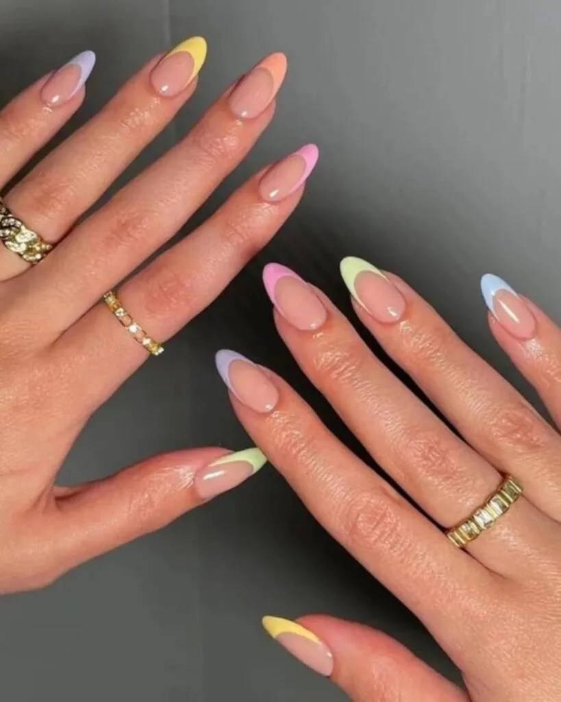 spring nail trends 2026, almond nails with multicolor pastel French tips on sheer base