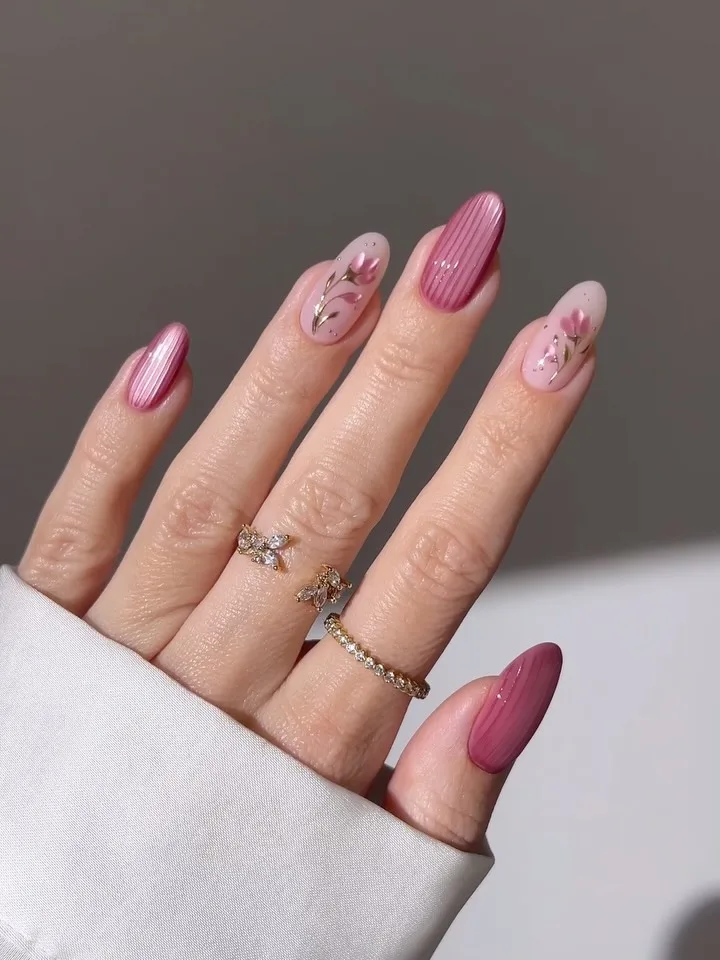 may nails, almond dusty rose velvet nails with pink pinstripes, sheer floral art, and gold leaf accents
