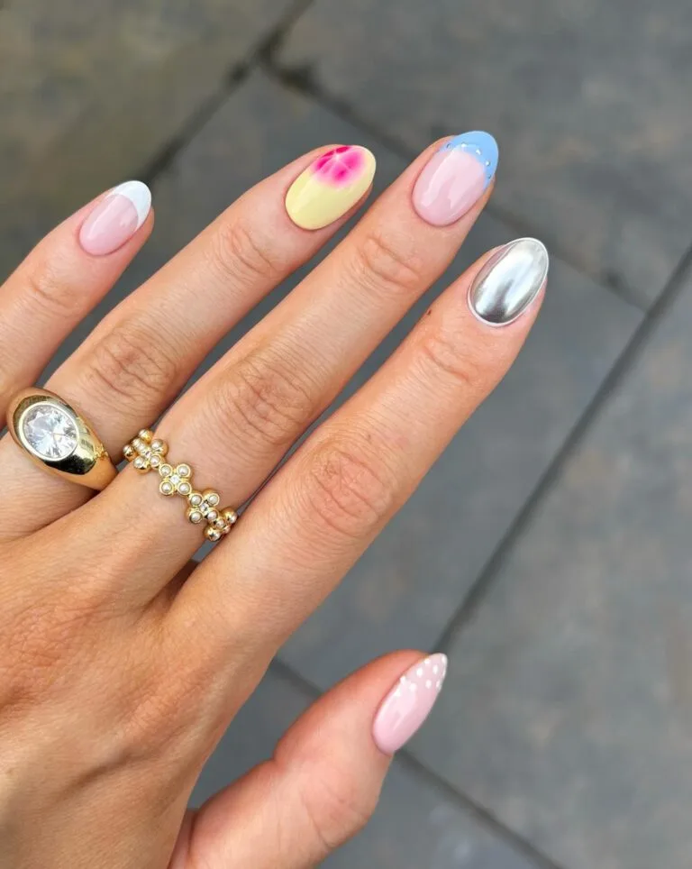 may nails, almond pastel mix-and-match nails with white French tip, yellow aura, blue rhinestones, and silver chrome