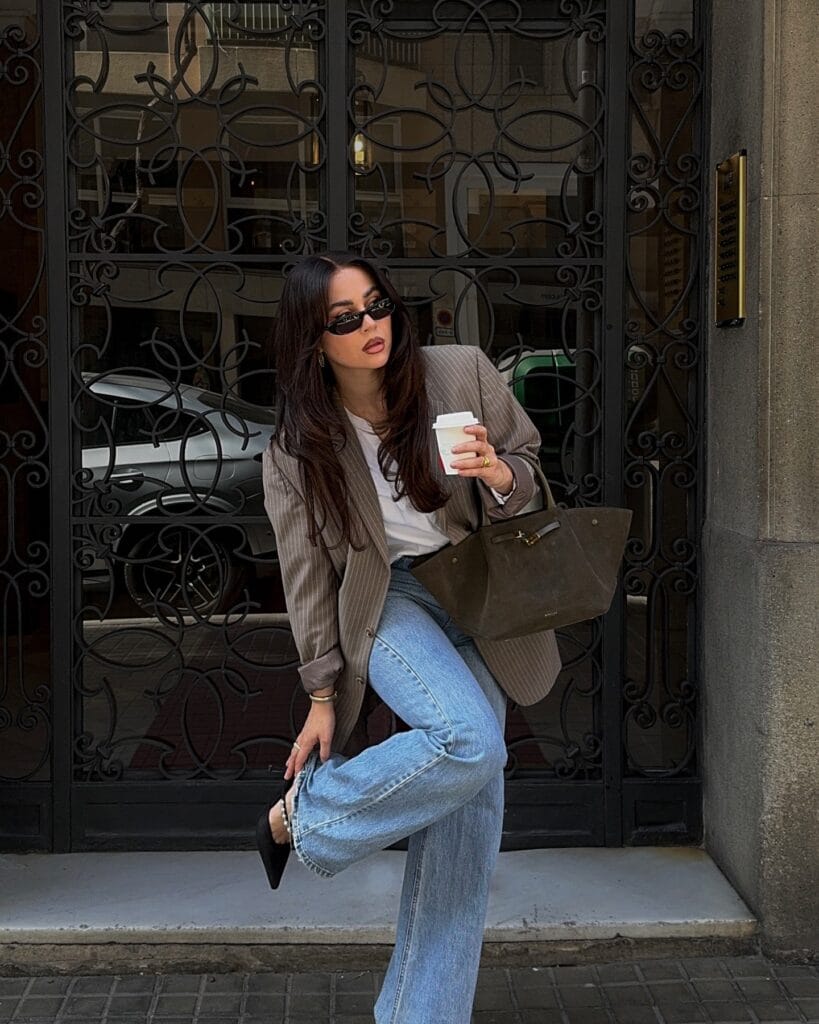 may outfit with taupe pinstripe blazer, white tee, light wash straight-leg jeans, and black pointed flats
