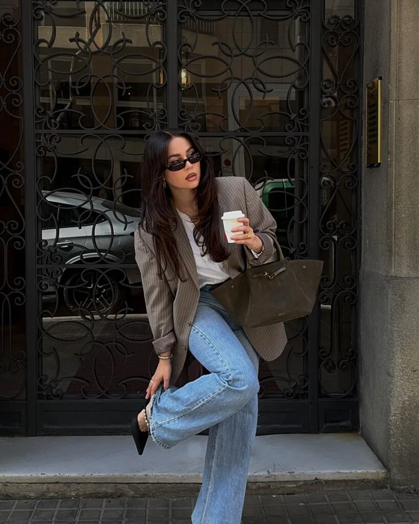 may outfit with taupe pinstripe blazer, white tee, light wash straight-leg jeans, and black pointed flats
