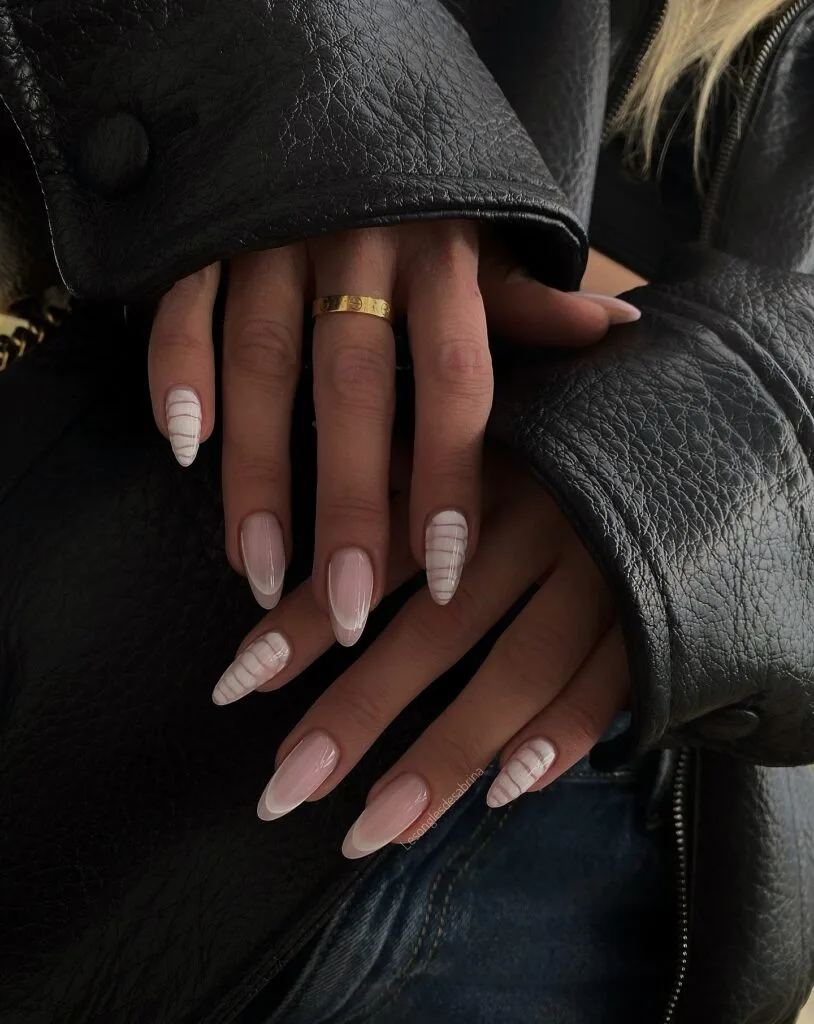 may nails, almond sheer milky pink nails with subtle white crocodile texture pattern accents

