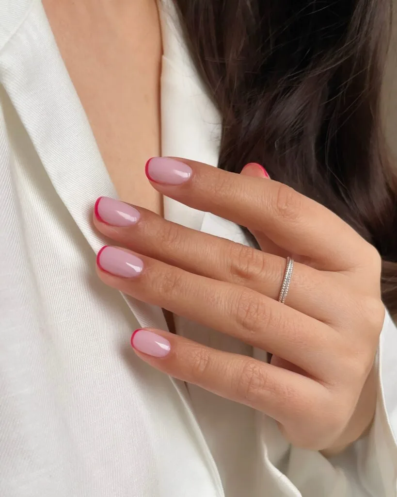 simple spring nails, short square nude pink nails with thin hot pink French tips
