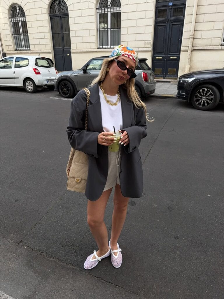 may outfit with grey oversized blazer, white tee, beige linen shorts, and white mesh ballet flats

