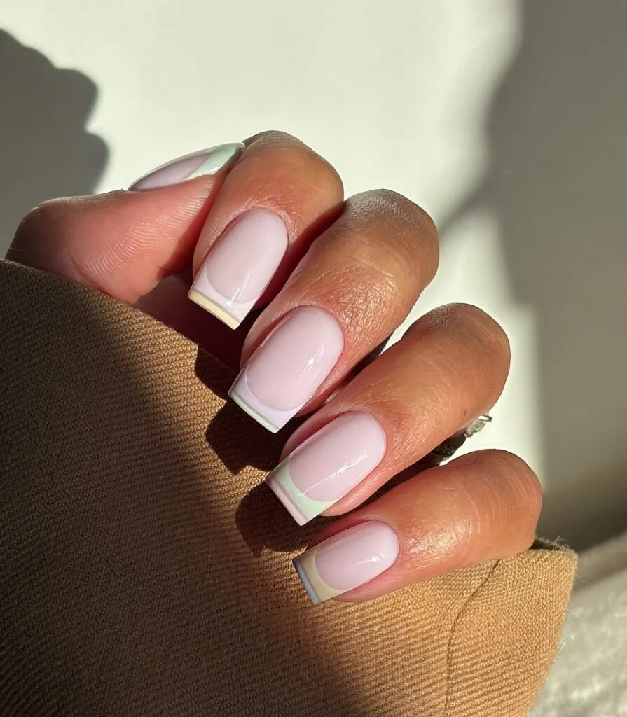 may nails, short square sheer nude nails with pastel rainbow striped French tips in pink yellow blue and mint
