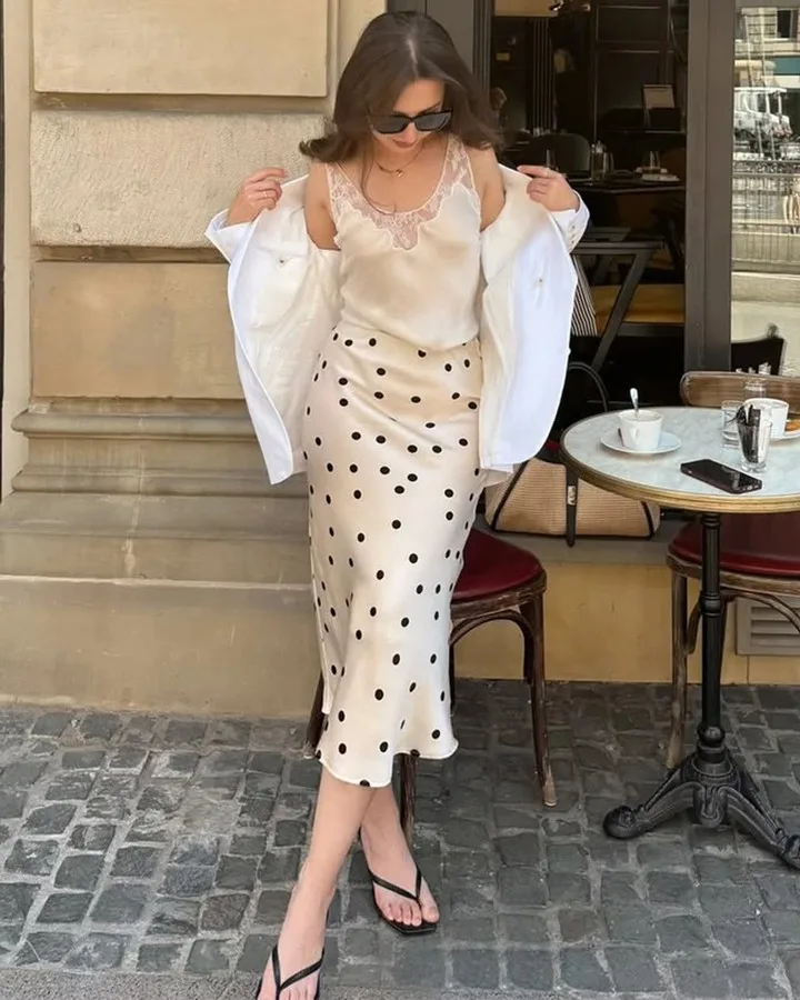 spring fashion trends 2026, champagne satin cami and polka dot silk midi skirt with white shirt