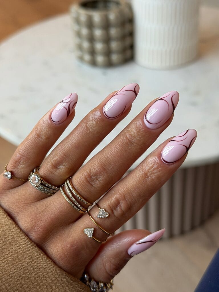 simple spring nails, almond pink nails with thin brown abstract swirl line art