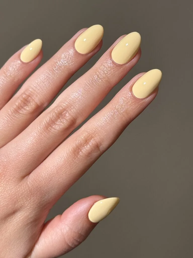 may nails, almond glossy butter yellow solid color nails
