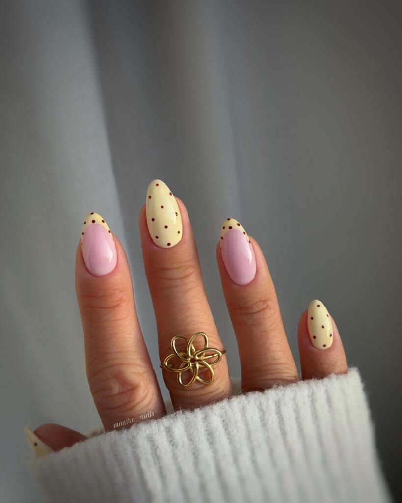 simple spring nails, almond pale yellow French tips with brown polka dots on sheer pink base