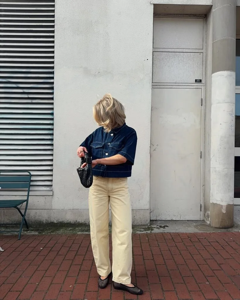 spring fashion trends 2026, black woven mesh flats with cropped dark denim jacket and cream trousers