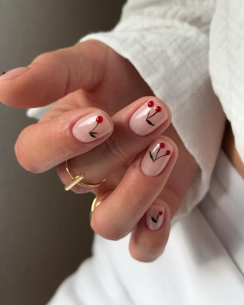 may nails, short square sheer pink nails with minimalist red cherry and black stem doodle accents
