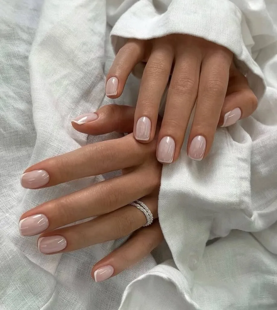 simple spring nails, short square milky sheer nails with subtle nude French tips
