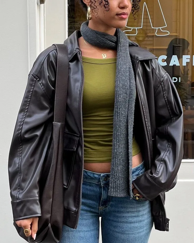 spring fashion trends 2026, grey knit skinny scarf wrapped at neck with black leather jacket