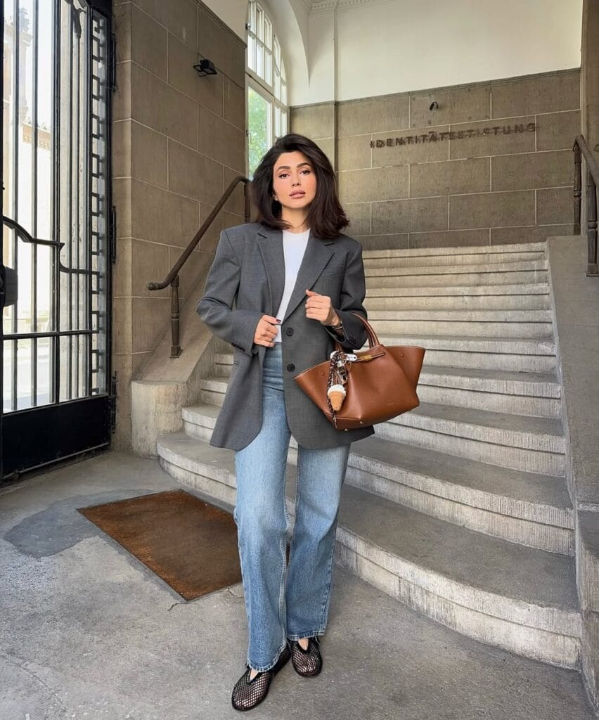 may outfit with oversized grey blazer, white tee, light wash jeans, cognac leather tote, and black mesh flats
