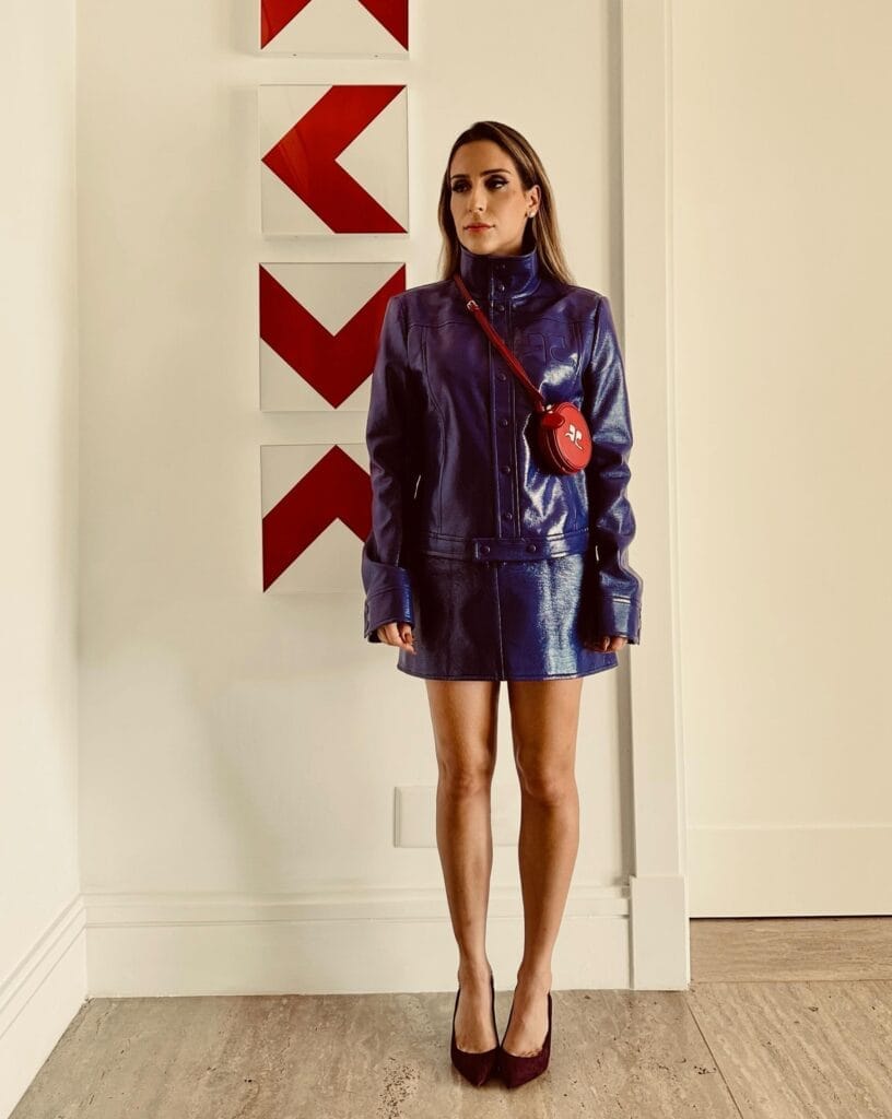 spring fashion trends 2026, purple leather jacket and mini skirt set with red crossbody bag