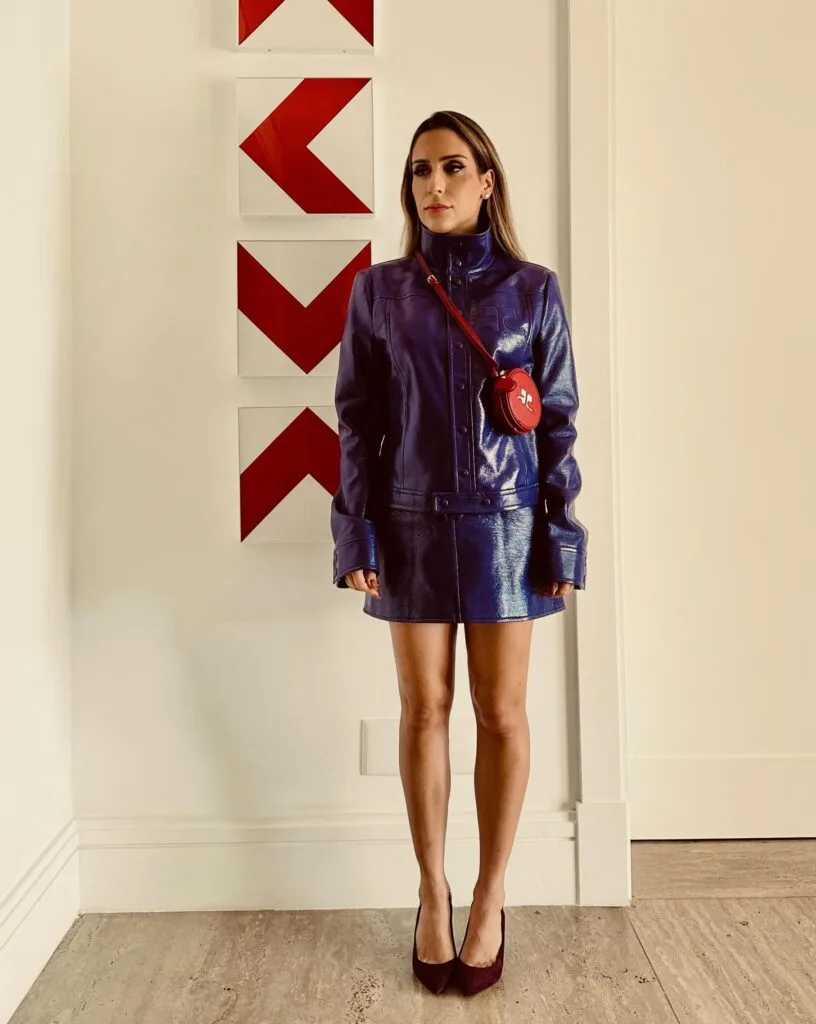 spring fashion trends 2026, purple leather jacket and mini skirt set with red crossbody bag