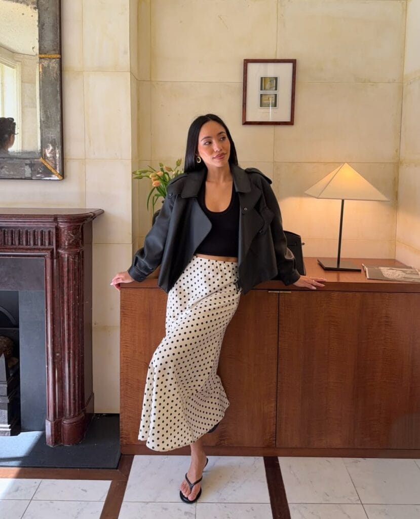 may outfit with black leather jacket, black crop tank top, cream and black polka dot midi skirt, and black flip flops
