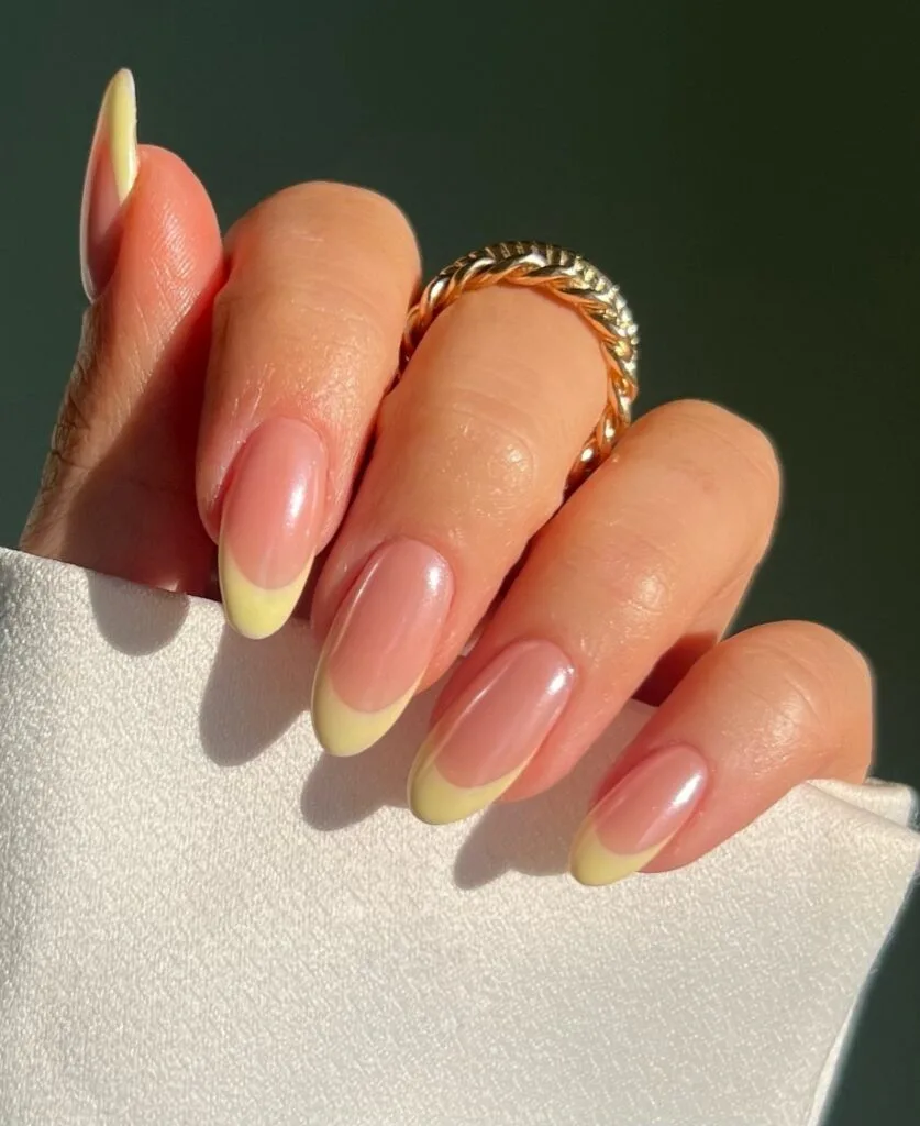 may nail colors, soft yellow French tips on nude almond nails