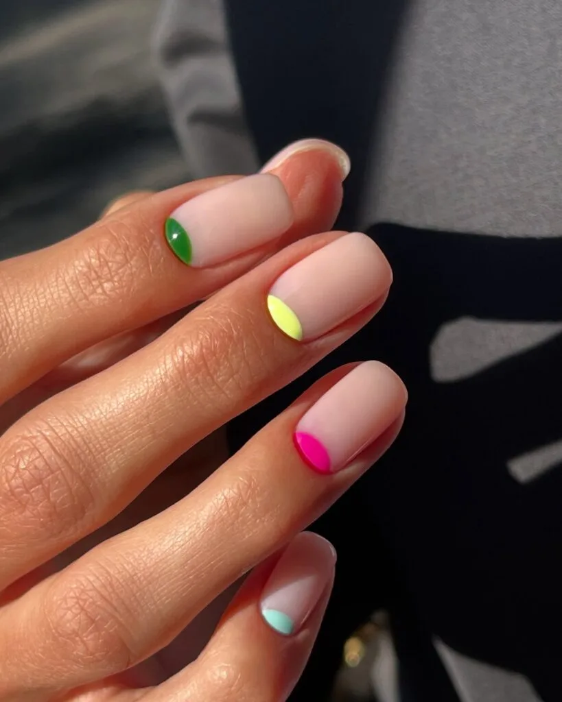 simple spring nails, short nude nails with colorful half-moon cuticle accents in green yellow pink and mint
