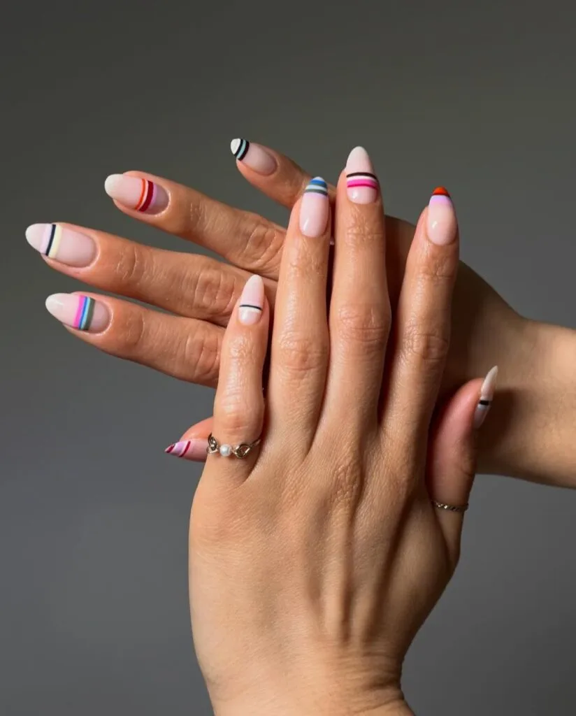 summer nail trends 2026, multicolor striped almond nails with thin pinstripes on sheer base