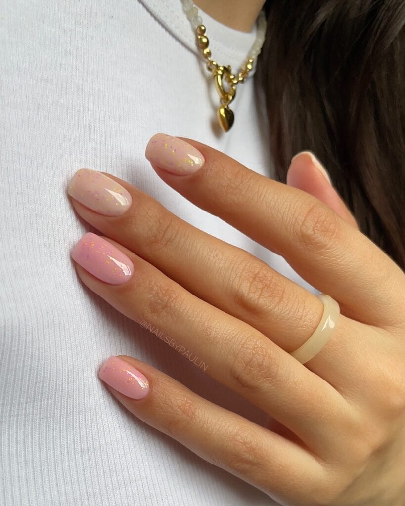 neutral summer nails, short square sheer pink and beige nails with scattered gold foil flecks and glossy finish
