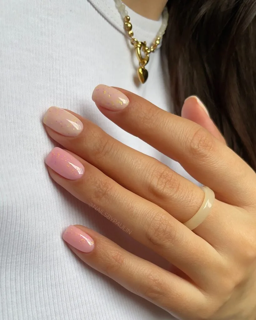 neutral summer nails, short square sheer pink and beige nails with scattered gold foil flecks and glossy finish
