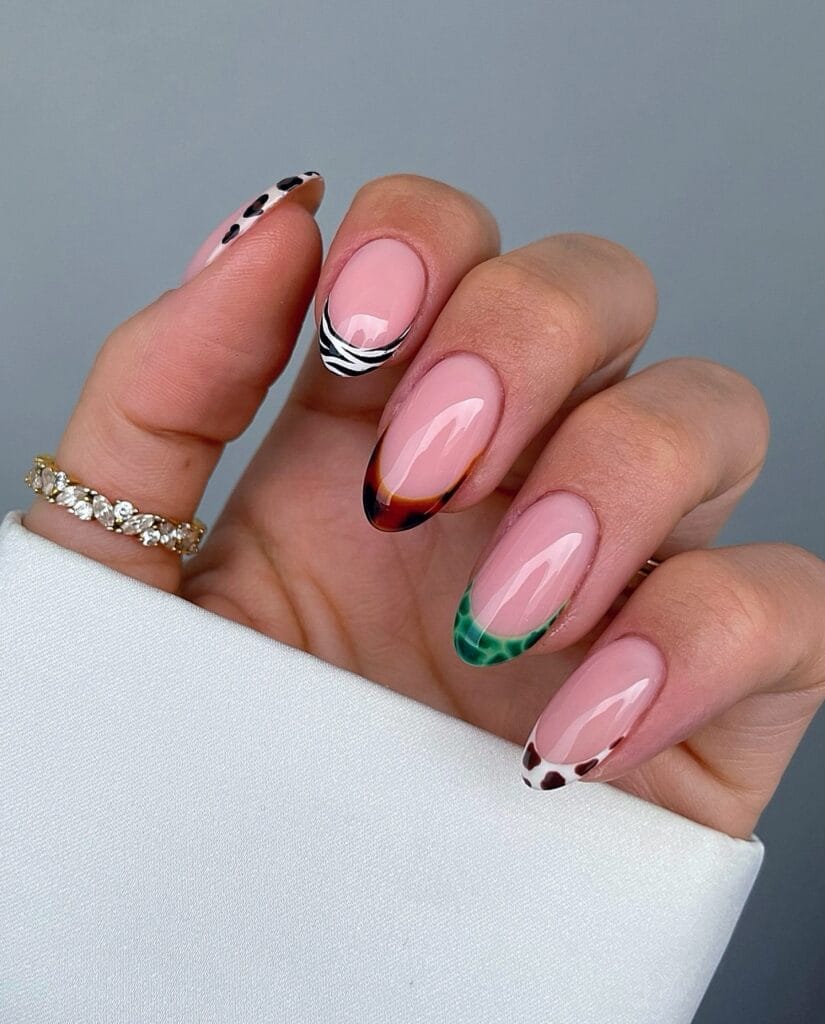 June nail ideas, mix and match animal print French tip almond nails with zebra leopard and tortoiseshell
