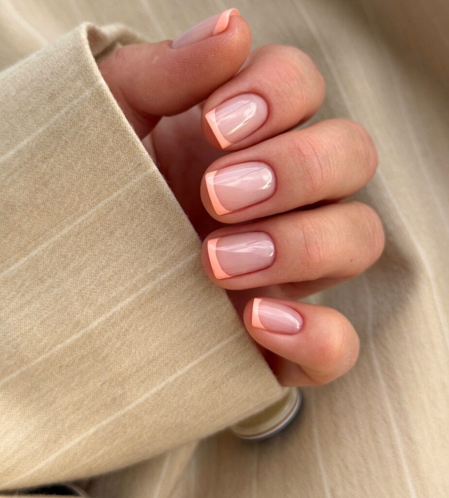 neutral summer nails, short square sheer nude nails with soft peach French tips
