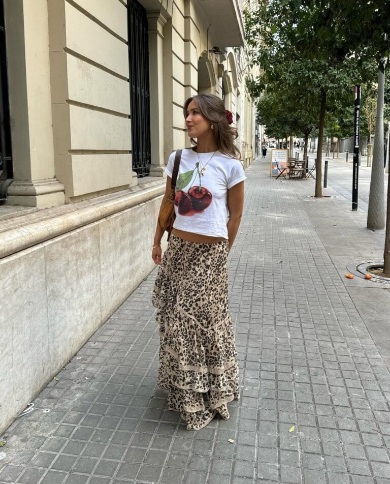 june outfit with white cherry graphic tee, leopard print tiered maxi skirt, and brown shoulder bag