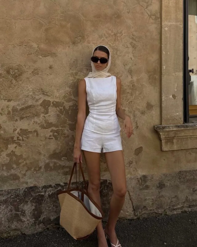 summer fashion trends 2026, all-white linen top and matching shorts with silk headscarf and straw tote