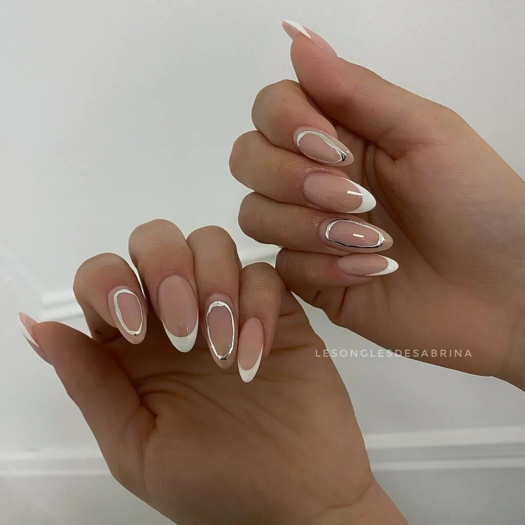 June nail ideas, white French tip almond nails with thin silver chrome outline detail
