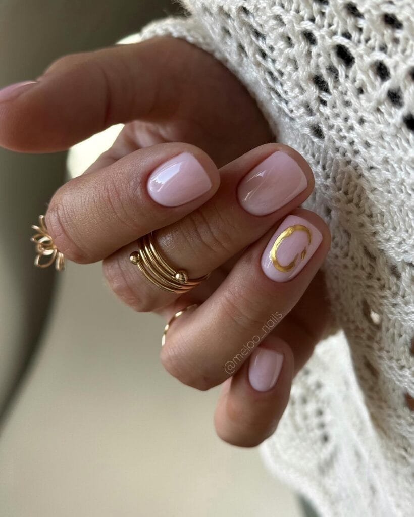 June nail ideas, sheer milky pink short square nails with abstract gold brushstroke accent nail
