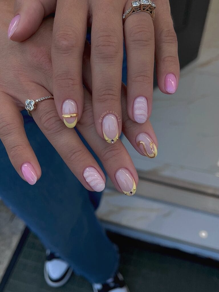 July nail ideas, milky pink mix oval nails with white marble swirls yellow French tips and gold waves
