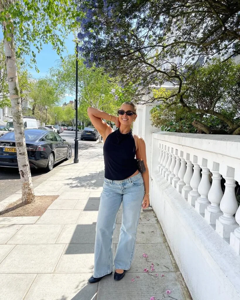 summer outfit with black halter tank top, light wash wide-leg jeans, and black ballet flats
