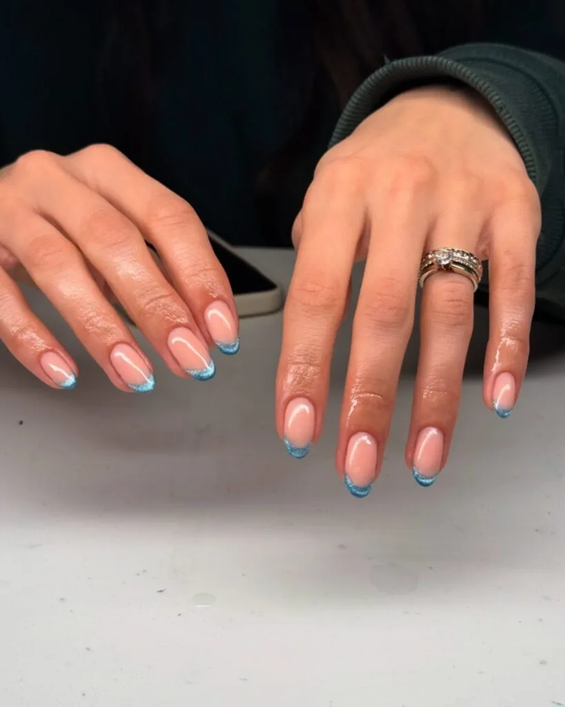 june nail color trends, ocean blue glitter French tip nails on sheer nude base