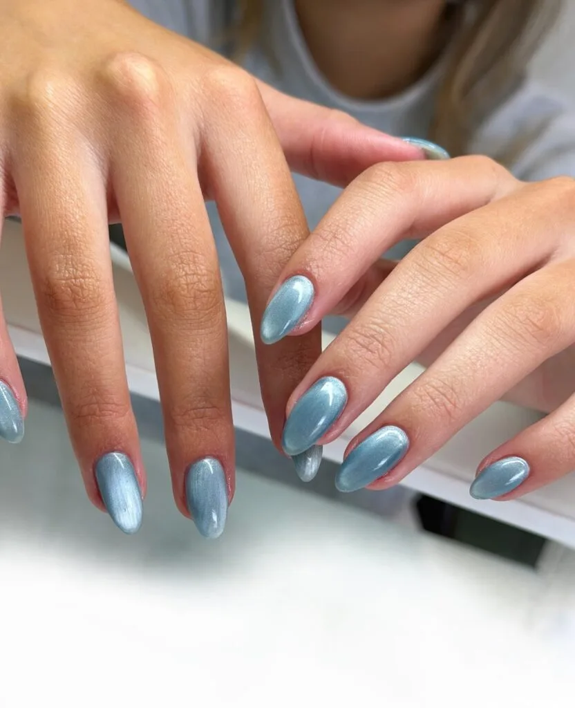 june nail color trends, icy blue cat eye almond nails with pearlescent glow