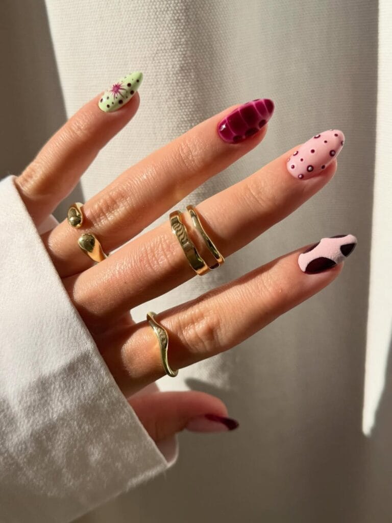 June nail ideas, eclectic mix and match almond nails with croc texture polka dots starburst and cow print