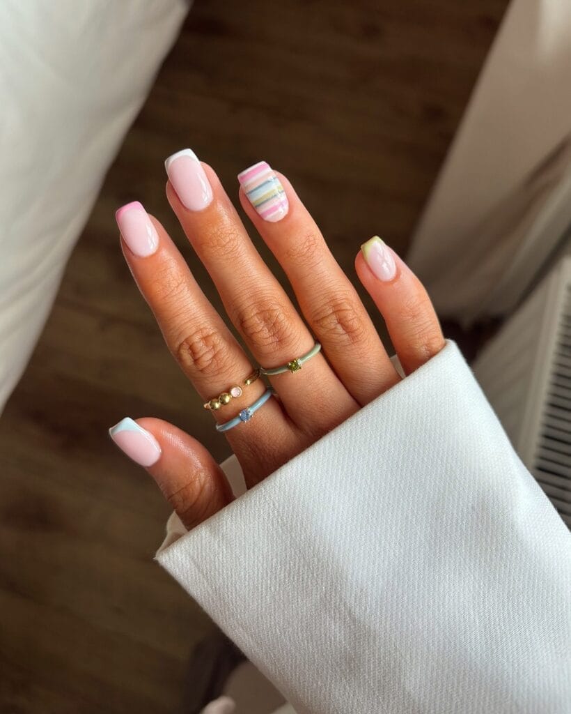 June nail ideas, baby pink short square nails with pastel French tips and candy stripe accent nail
